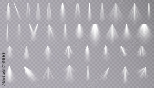 Set of isolated spotlight light effects. White glowing spotlight on a transparent background.	