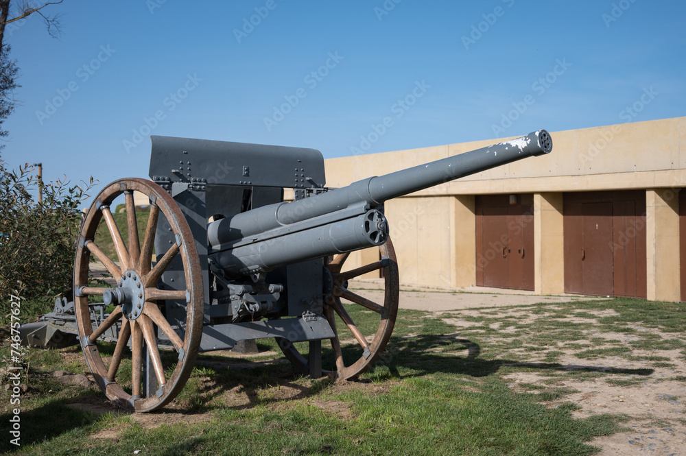 Detail of an old military field cannon with wooden spoke carriage wheels at Longues-sur-Mer battery (Batterie de Longues-sur-Mer)