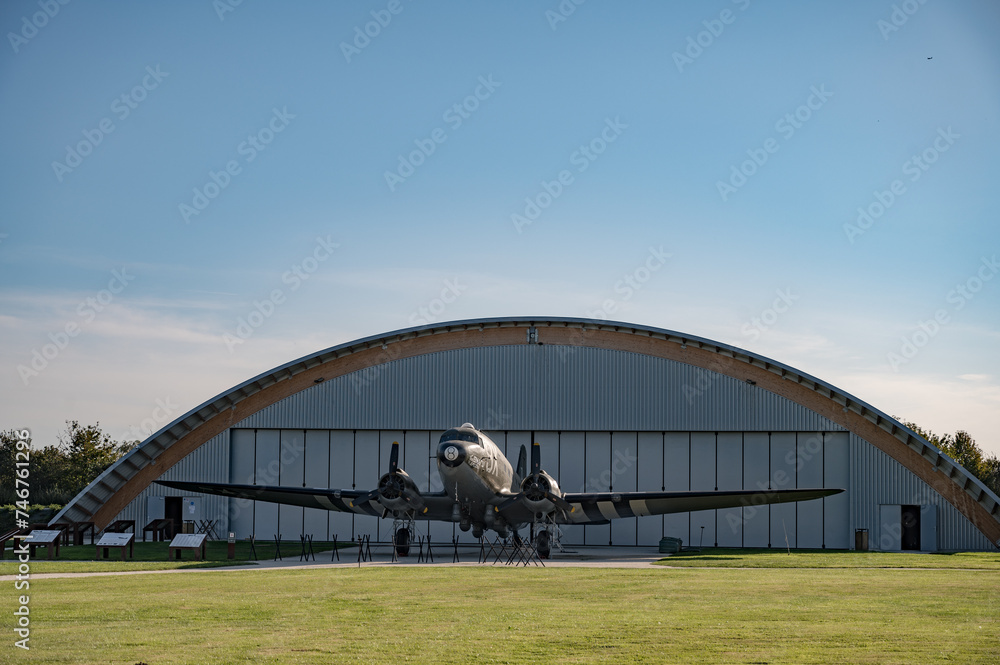 Detail of the large American twin-engine C-47 Dakota Skytrain aircraft from the Second World War in front of the hangar at Museum and the Merville Battery site Detail of the large American twin-engine C-47 Dakota Skytrain aircraft from the Second World War in front of the hangar at Museum and the Merville Battery site