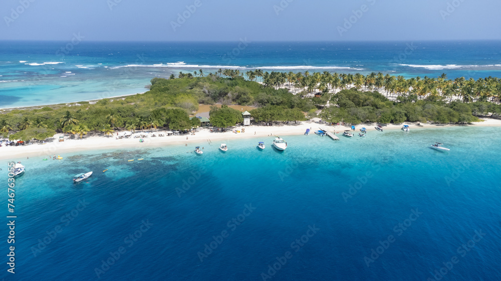 View of a small white sandy cay in the deep blue sea