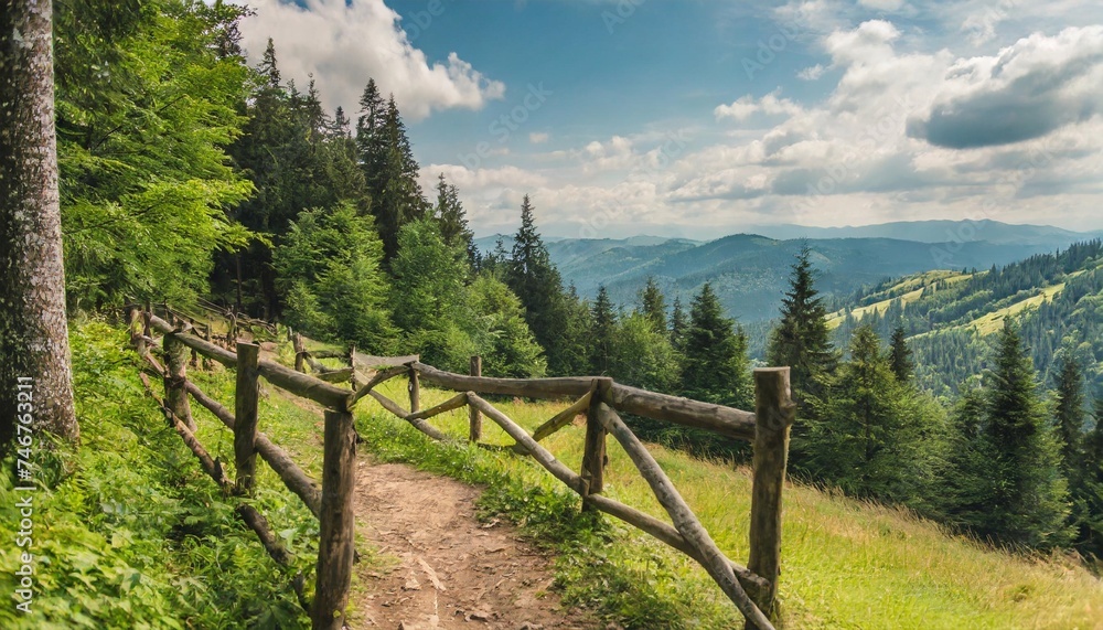 green summer scene in carpathian woods outdoor scenery with trail and wooden fence in the forest