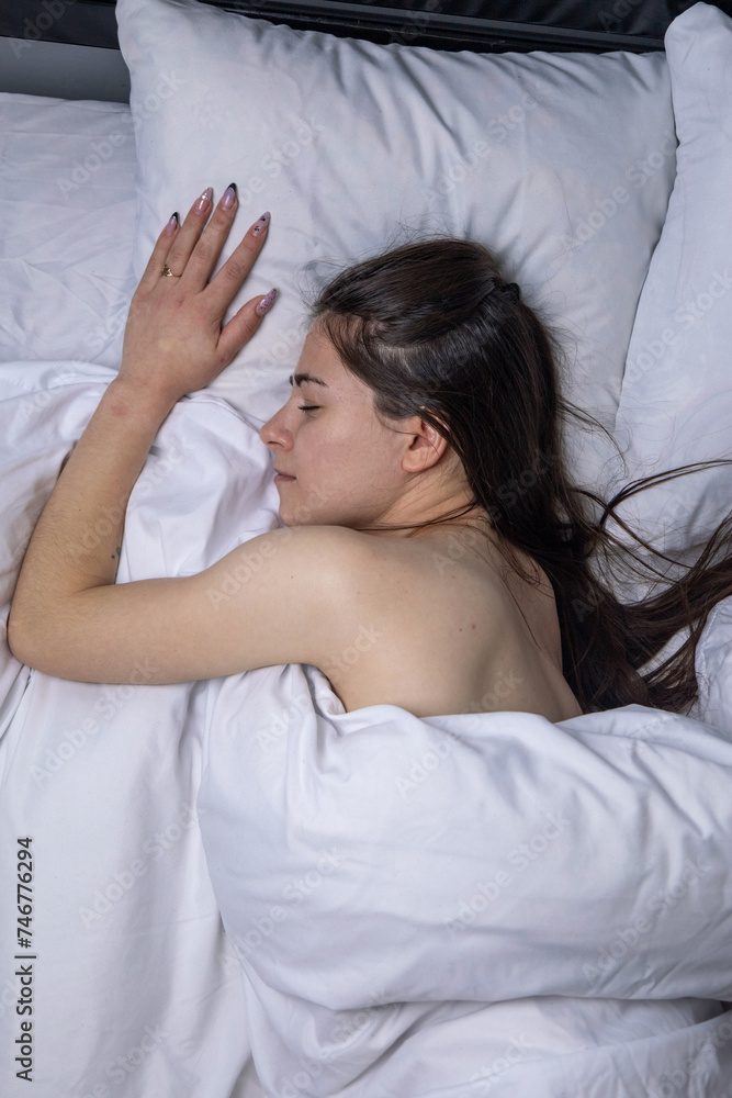 The girl sleeps in a white bed The girl sleeps in a white bed