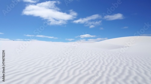 Beautiful white sand dunes on a background of the blue sky