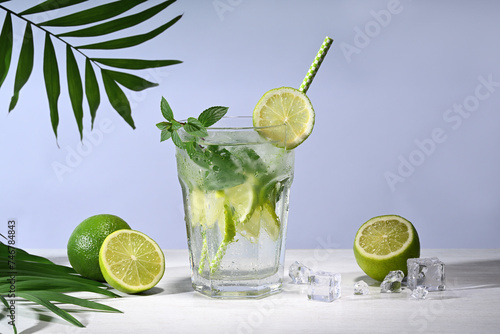 Glass with mojito cocktail and limes