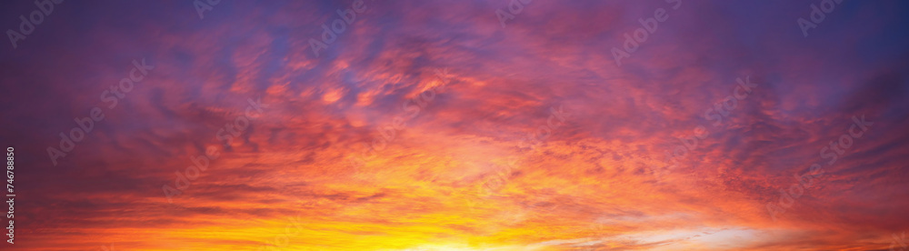 Dramatic dusk sky with clouds. Mysterious abstract heaven background pattern texture at sunset.  Wide banner panorama.