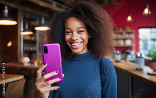 female girl smiling while holding mobile phone