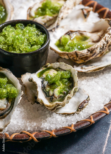 Oysters With Spicy Cucumber & Lime Granita, gteen fresh basil, blue background