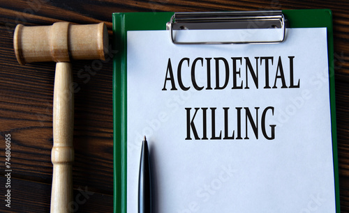 ACCIDENTAL KILLING - words on a white sheet with a judge's gavel photo