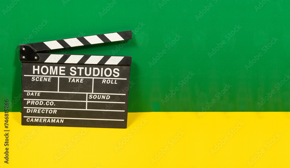 Naklejka premium clapperboard closeup with colorful wall- blogging and movies theme