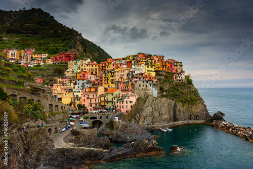 The colorful town of Manarola with cloudy dramatic sky, Cinque Terre, Liguria, Italy