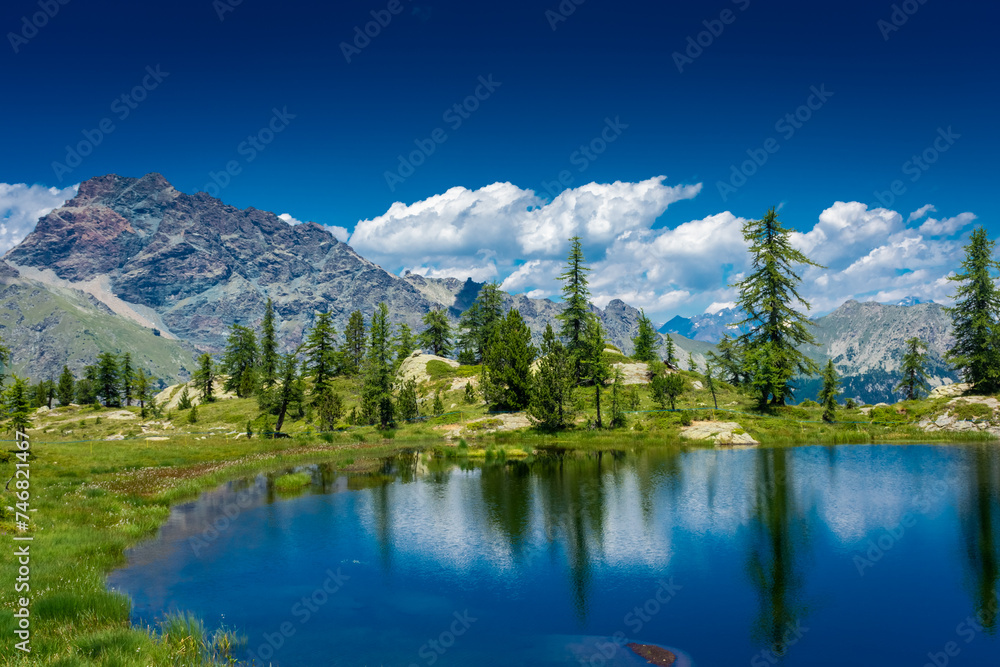 Reflection on the Mount Avic Lake in Aosta Valley,  Italy