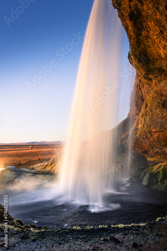 Amazing view from behind the Seljalandsfoss Waterfall at sunset   Iceland