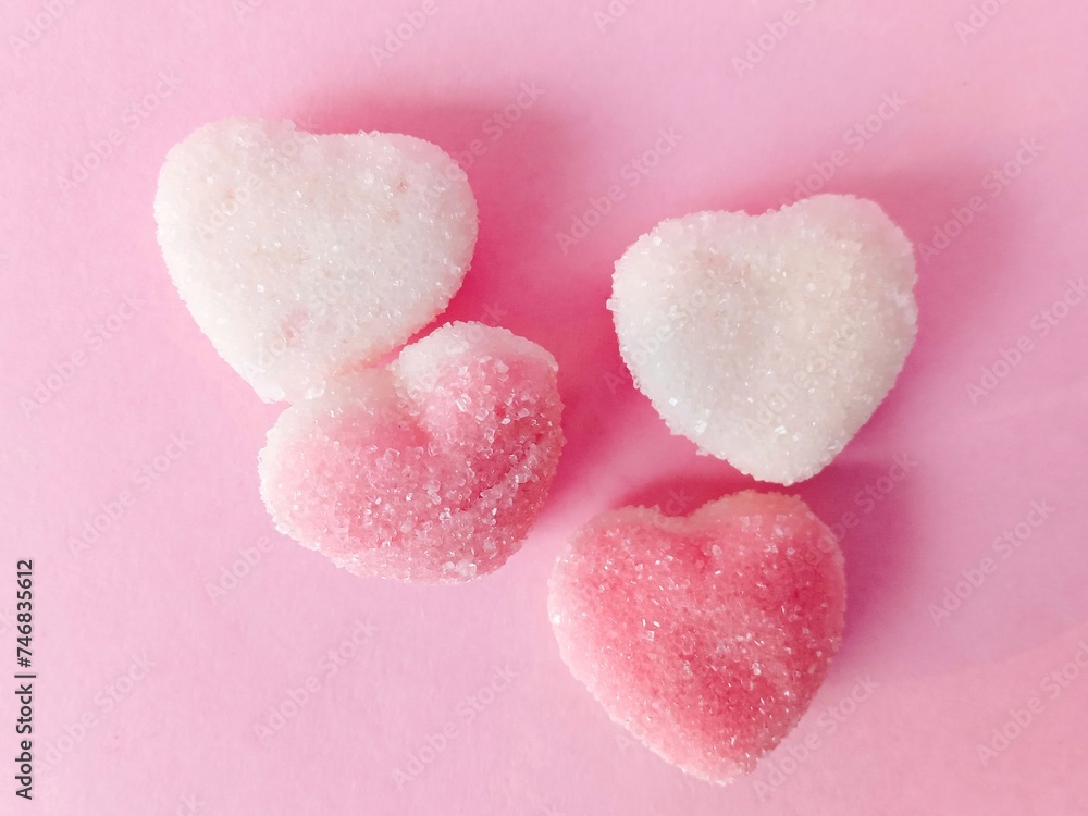 a group of pink and white heart-shaped chewy candies on a pink background. chewy candy sprinkled with granulated sugar. sweet and chewy
a group of pink and white heart-shaped chewy candies on a pink background. chewy candy sprinkled with granulated sugar. sweet and chewy