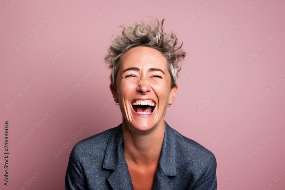 Portrait of a happy business woman laughing on a pink background. Portrait of a happy business woman laughing on a pink background.