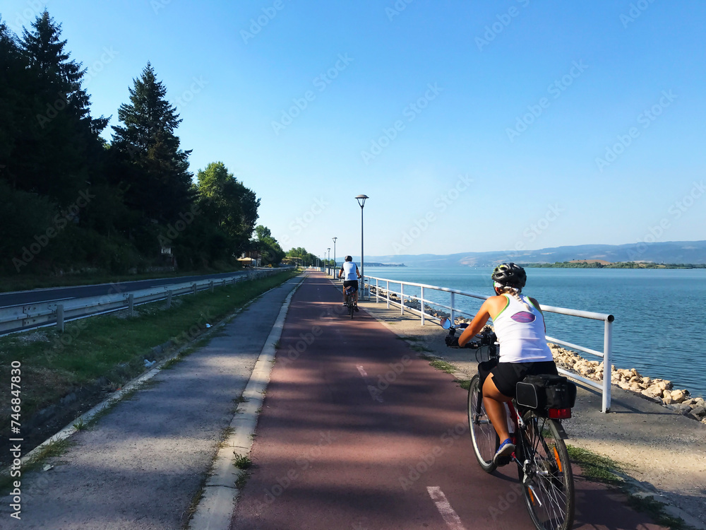 Two cyclists on the cycle path that stretches along the Danube near Golubac in Serbia Two cyclists on the cycle path that stretches along the Danube near Golubac in Serbia