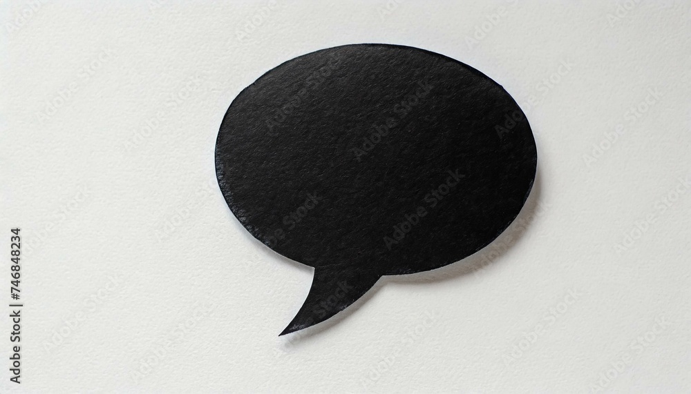 Black paper cut out speech bubble shape set on white paper background. Black paper cut out speech bubble shape set on white paper background.