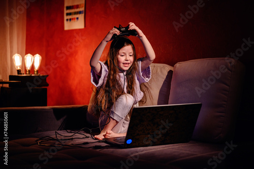 A young girl shouts in excitement while holding a game controller, her dynamic reaction capturing the thrilling moments of gameplay