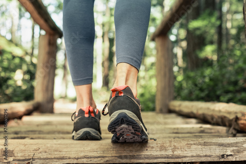 Closeup of Female Walking in the woods exercising. Active Lifestyle concept 