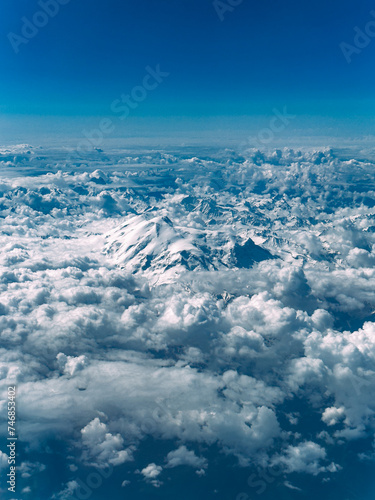 Aerial View of Steep Rocky Snowcapped Mountain Range on Beautiful Sunny Day