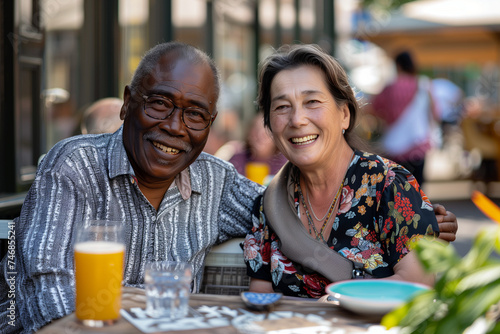 Happy Interracial Mixed Race Retired Old Couple at Cafe Bar Restaurant Outside