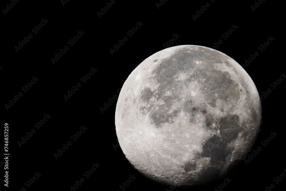 Naklejka premium The moon is 18 days old and is in the Waning Gibbous phase of its lunar cycle