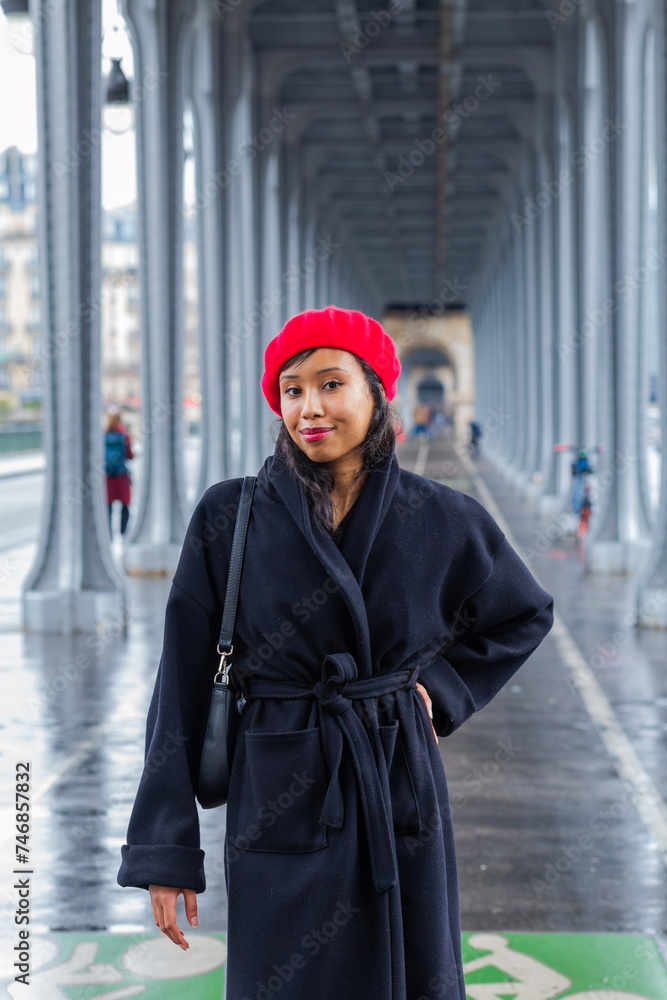 Obraz premium Young beautiful happy woman in red French beret in Paris, France against Eiffel Tower. European tourism and travels to the capital cities