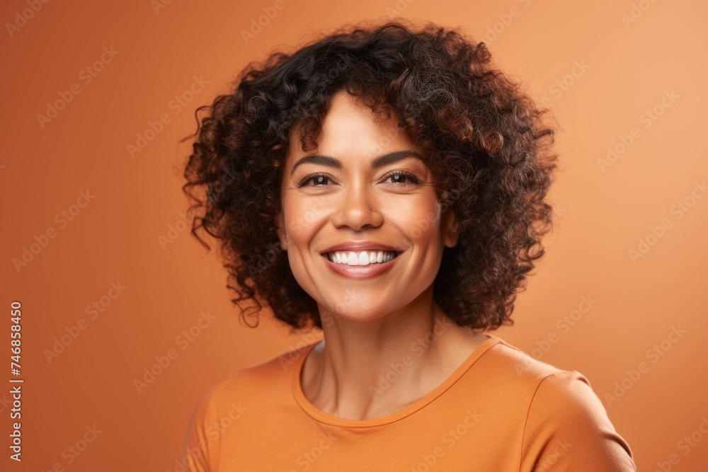 Portrait of smiling african american woman on orange background. Portrait of smiling african american woman on orange background.