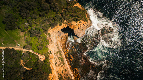 Stunning ocean view of the waves and beach in the Northern Beaches of NSW, Sydney, Australia. The view was captured from above using a drone.