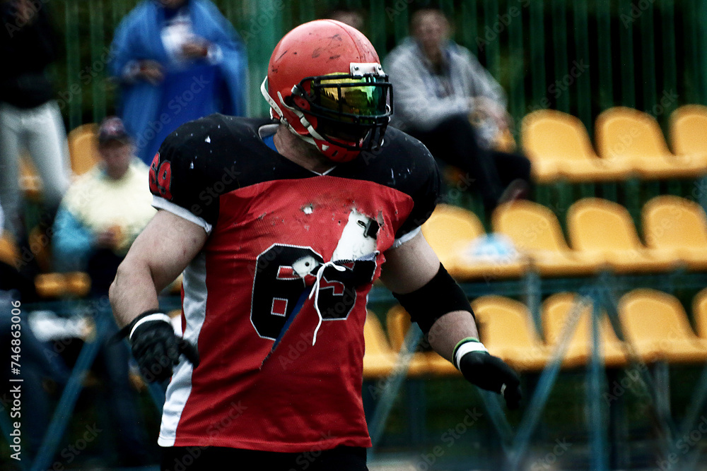 Big American football player in torn uniform
Big American football player in torn uniform