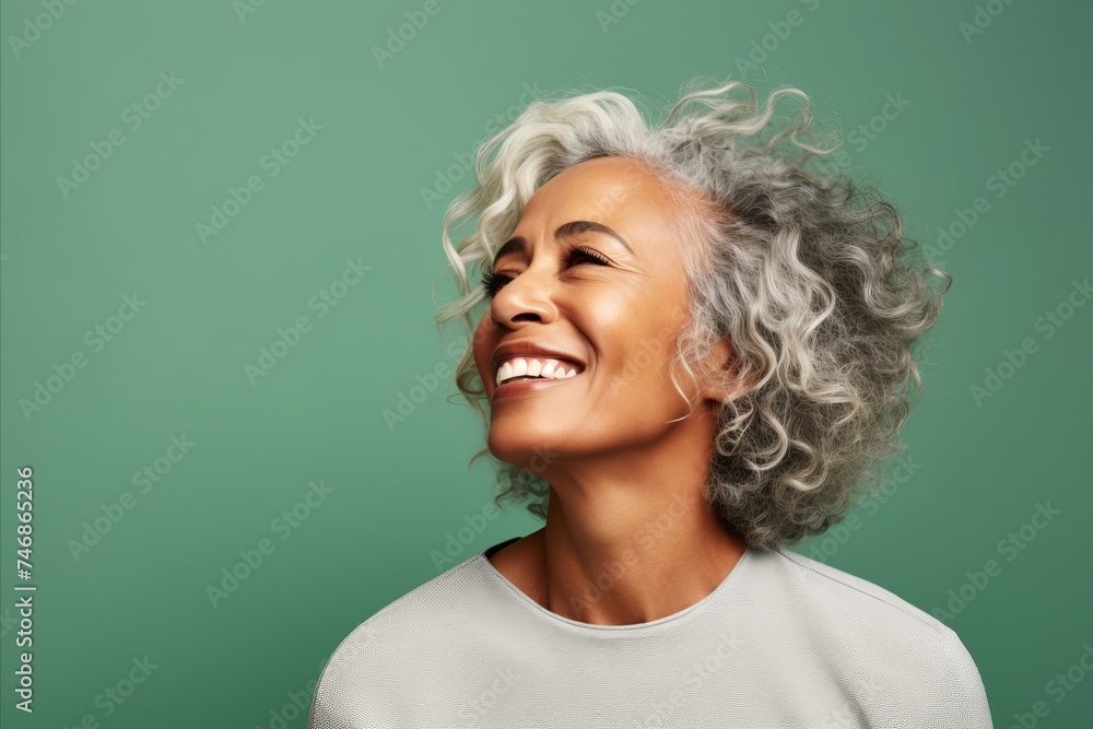 happy african american woman with curly hair laughing over green background happy african american woman with curly hair laughing over green background