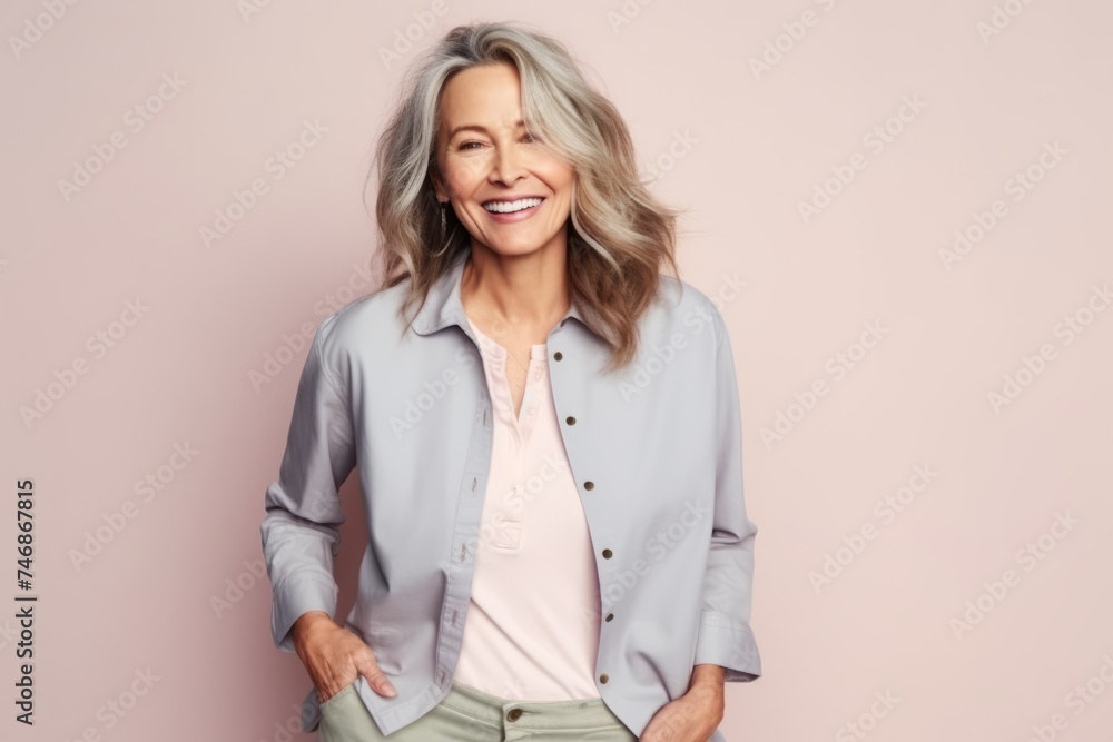 Portrait of a happy senior woman posing on a pink background. Portrait of a happy senior woman posing on a pink background.