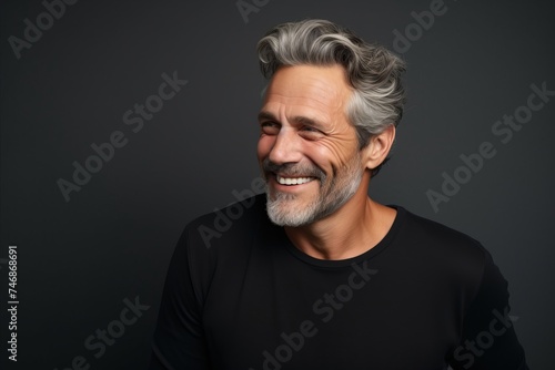 Handsome middle-aged man with grey hair and beard.