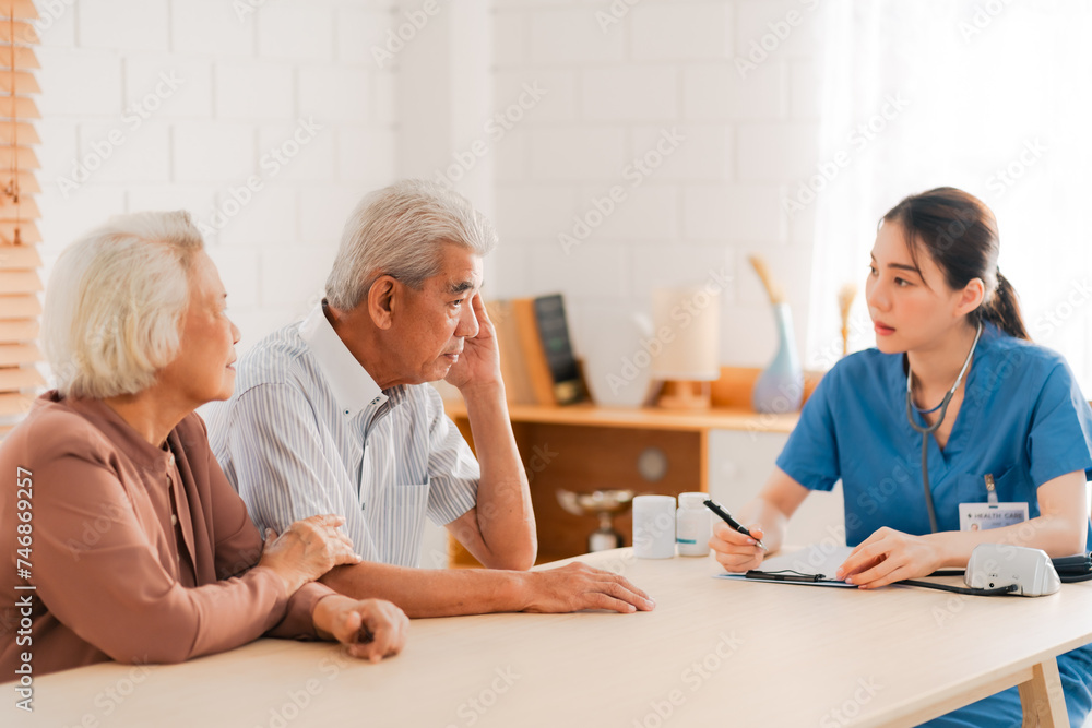 Health insurance service, Young Asian caregiver nurse examine senior man or woman patient at home. Attractive specialist career female support give advise and therapy consult to older elderly mature Health insurance service, Young Asian caregiver nurse examine senior man or woman patient at home. Attractive specialist career female support give advise and therapy consult to older elderly mature