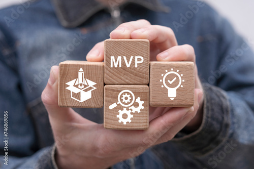 Canvas Print Man holding wooden cubes sees abbreviation: MVP