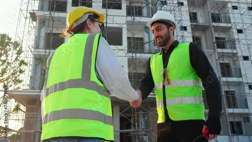 Happy team of architect or engineer with success and glad while handshake together at construction site, team contractor or partner glad with achievement about successful of project, industry concept.
