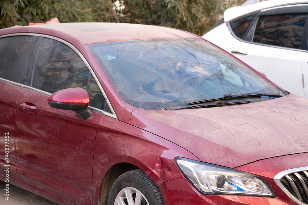 Red cars covered in dust