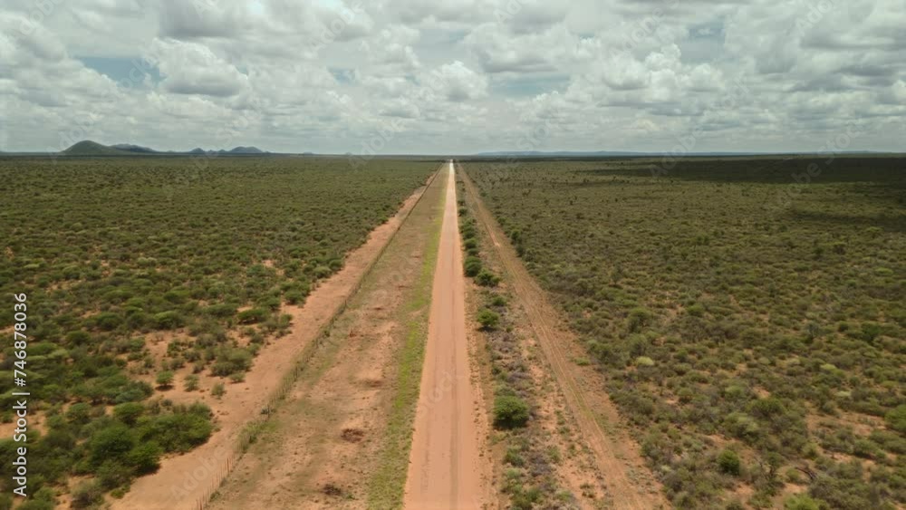 Long gravel road in an empty green landscape. Long gravel road in an empty green landscape.