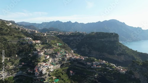 Pogerola and terrace of infinity in italy, sunlight bathing the landscape, aerial view photo