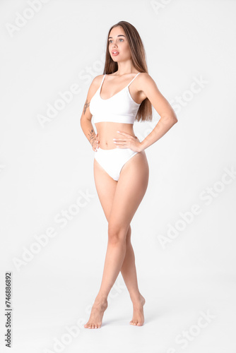 Beautiful woman in underwear on light background © Pixel-Shot