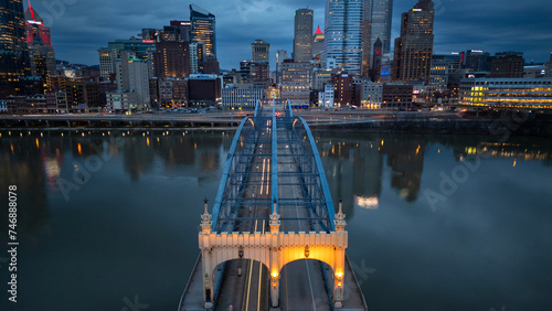 Steel Bridge Crossing River into City at Dusk