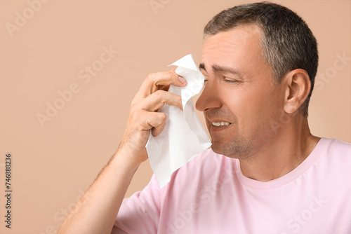 Ill mature man with tissue ...