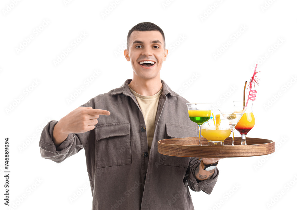 Young male bartender pointing at glasses of cocktail on white background Young male bartender pointing at glasses of cocktail on white background
