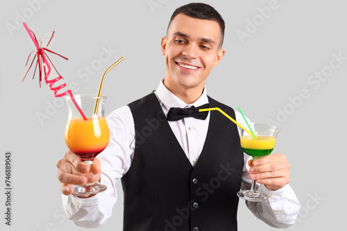 Young male bartender with g...