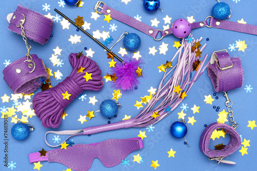 Sex toys with Christmas decor on blue background