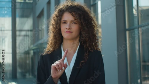 Confident woman Caucasian business girl in city serious looking at camera shaking finger prohibit warning gesture stop no never warn refuse deny female dissatisfied businesswoman waving hand forbid photo