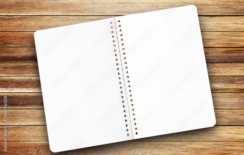 Top view blank paper notepad on wood table background Top view blank paper notepad on wood table background