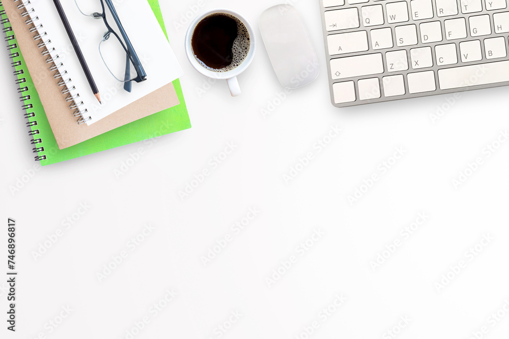 Cup of coffee, notebook with office tools and mini mouse and keyboard wireless on white office desk background. Cup of coffee, notebook with office tools and mini mouse and keyboard wireless on white office desk background.