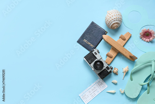 Wallpaper Mural Composition with wooden plane, passport, photo camera and seashells on color background. International Women's Day Torontodigital.ca