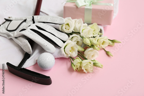 Composition with golf club, glove and beautiful flowers on pink background, closeup. International Women's Day photo