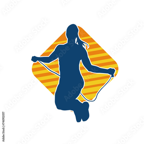 Silhouette of a slim sporty woman doing jump rope workout.